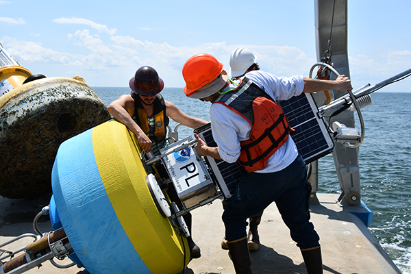 The NOAA CBIBS team prepares the new Potomac buoy to be deployed off Point Lookout in May 2019.