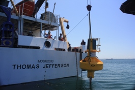 The First Landing buoy is deployed from the deck of the NOAA ship Thomas Jefferson.