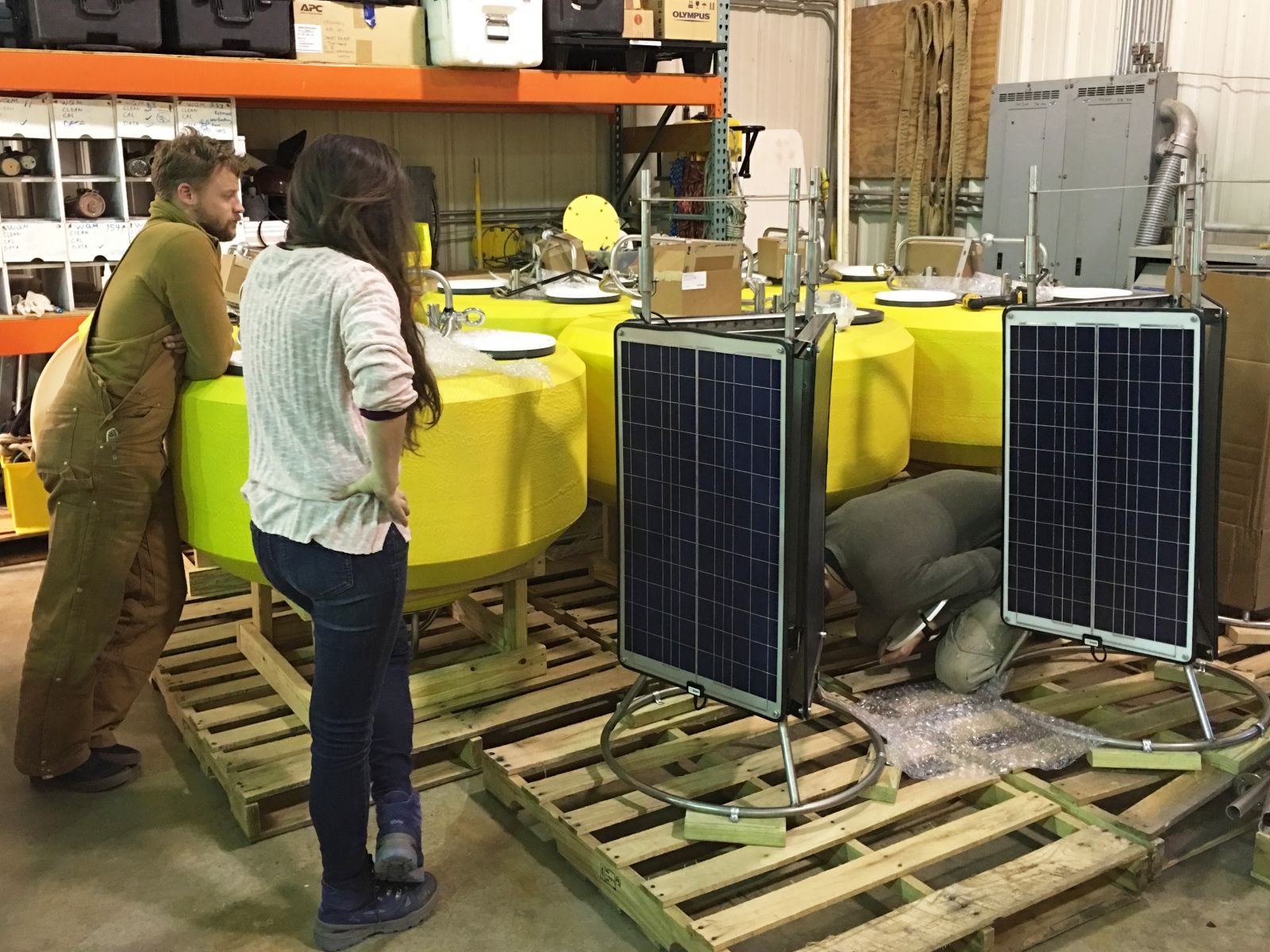 CBIBS team members inspect the new buoy hulls and top sections